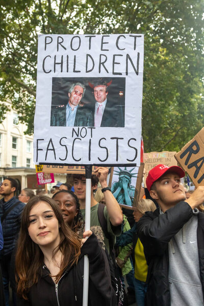 London, United Kingdom, September 17th 2025: The Stop Trump Coalition March in Central London. A Protester holds a sign showing trump and epstein and reading protect children not fascists