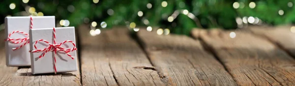 Banner of gifts on old wooden floor, christmas background bokeh