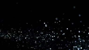 Soyut hareket arka planı parlayan ışık parçacıkları. Bokeh 'le parıldayan parçacıklar. Kusursuz 4K döngü video canlandırması