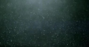 Uçan ve titreşen parçacıkların ışık demeti olarak canlandırıldığı soyut bir arkaplan. Kusursuz döngünün animasyonu. Toz baloncukları kar animasyonu..