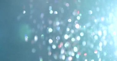 Uçan ve titreşen parçacıkların ışık demeti olarak canlandırıldığı soyut bir arkaplan. Kusursuz döngünün animasyonu. Toz baloncukları kar animasyonu..