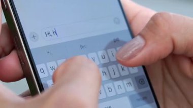 Kadın ellerinin kırpma görüntüsü arkadaşa dışarıdaki akıllı telefondan duyguları sorar. Kadın parmaklar, cep telefonu ekranında arkadaşa sokak kapanışında sanal klavye ile kısa mesaj yazar