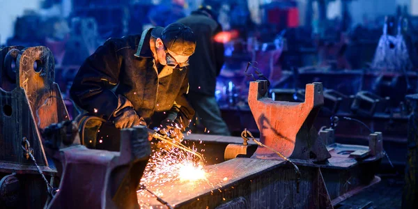 man welds factory