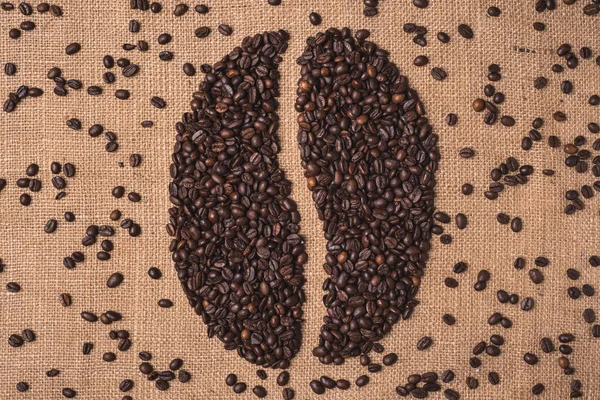 portrait toasted coffee shape beans top view on juta textile