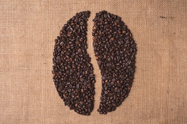 portrait toasted coffee shape beans top view on juta textile