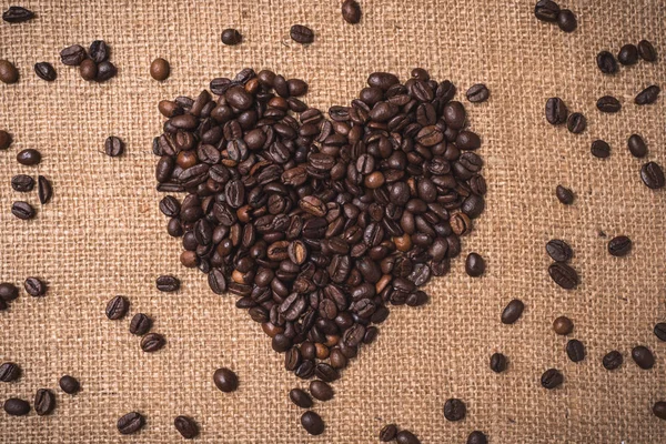 I love coffee words written with toasted coffee beans on top view composition