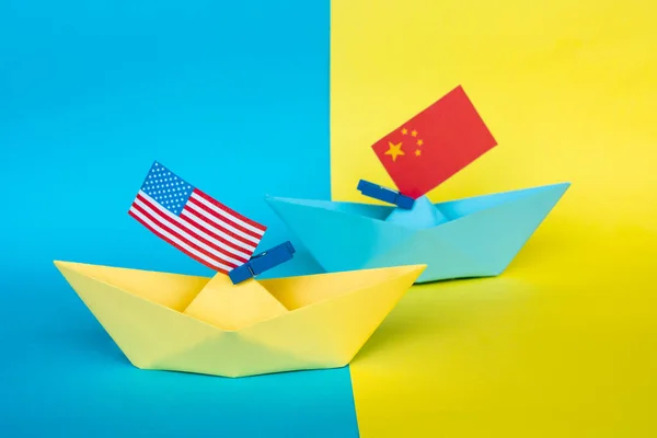 paper ship with Flags of USA and China concept of conflict, shipment or free trade agreement and membership