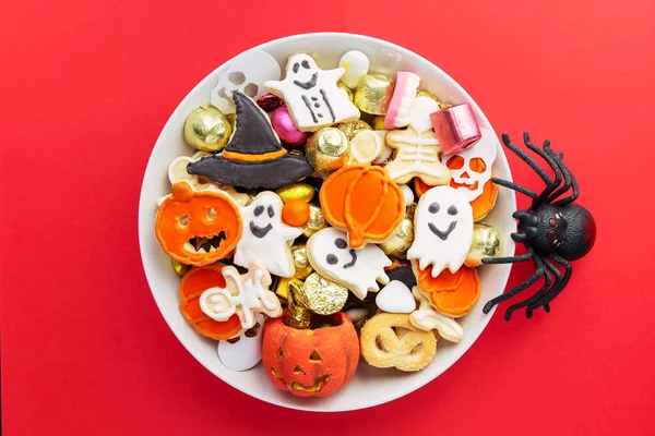 Halloween Jack o Lantern candy bowl with pumpkin sweets, candy and halloween cookies Trick or Treat