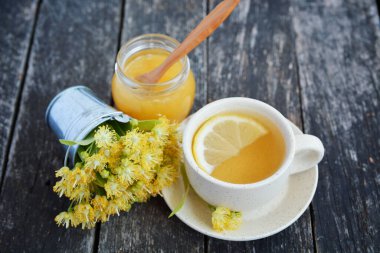 Kireç çiçekleri, bitkisel ilaçlar, bal ve limonlu bir fincan sağlıklı çay. alternatif ya da tamamlayıcı tıp, geleneksel tıp.