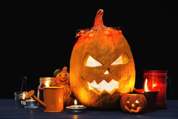 Halloween Jack o Lantern pumpkin on a black background in the fog. around candles, spiders, halloween Trick or Treat decor