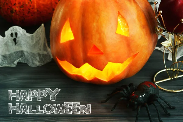 Halloween Jack o Lantern pumpkin on a black background in the fog. around candles, spiders, halloween Trick or Treat decor