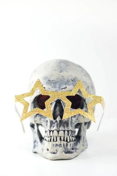 Halloween human gray skull imitation in festive star glasses on head. Decorating for holiday Halloween. Concept of eternal holiday. — Stock Photo, Image