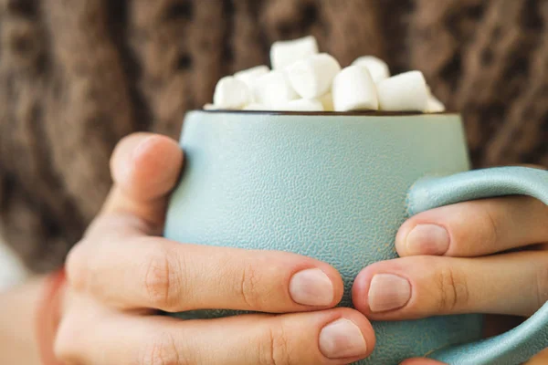 Mug biru dengan kopi, coklat panas atau coklat dengan marshmallow di tangan wanita. Konsep hangat nyaman musim gugur atau musim dingin . — Stok Foto