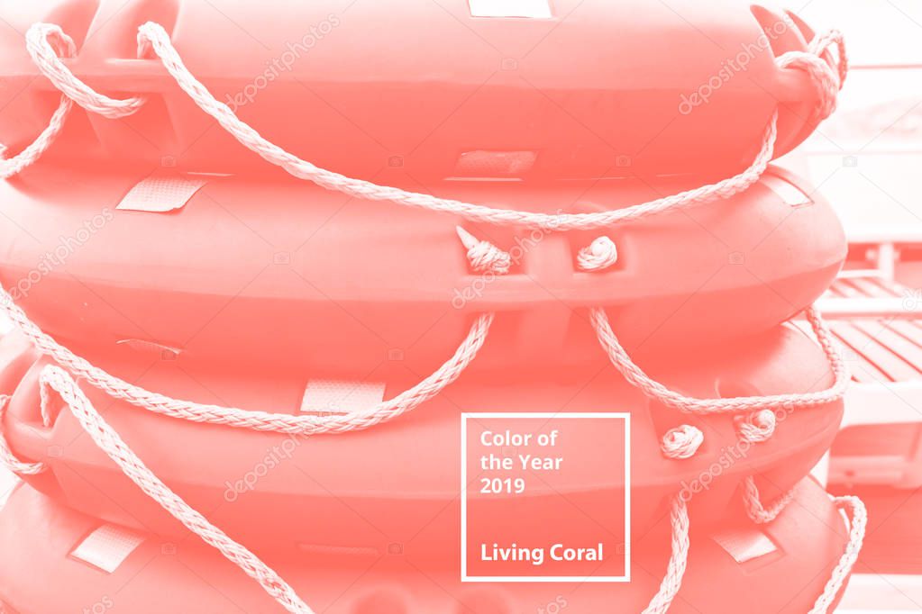 Lifebuoys on the ship are stacked. Color of the year 2019 Living Coral. Popular trend palette for design illustrations, fabrics, fashion, images. Tinted background.