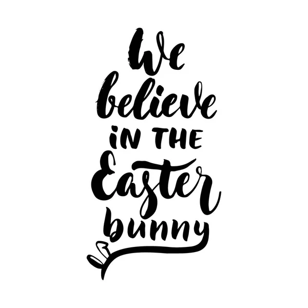 We believe in the Easter bunny - hand drawn lettering calligraphy phrase isolated on white background. Fun brush ink vector illustration for banners, greeting card, poster design, photo overlays. — Stock Vector