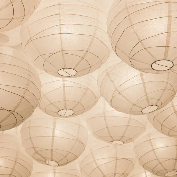Paper Chinese lamps on the ceiling. Abstract background in white color.