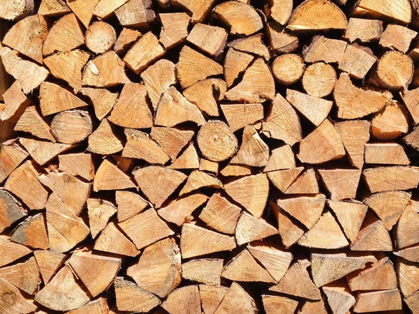 Fresh cut timber logs piled up in even rows,  background Germany 2019