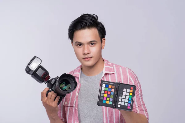 スタジオでの作業のデジタル カメラを保持している若いアジア写真家 — ストック写真