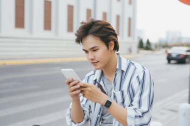 Telefonunuzun ve Bisiklet Park ile oturan genç adam