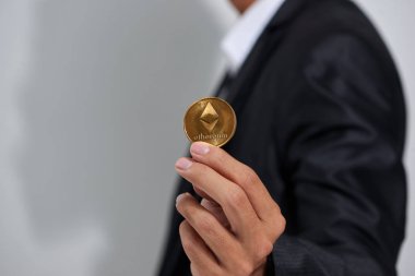 Erkek elinde, yeni sanal para birimi sembolü dijital altın Etherium