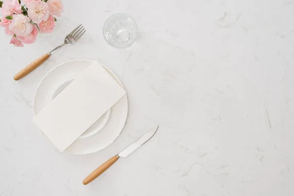 white plate without food with a fork and knife