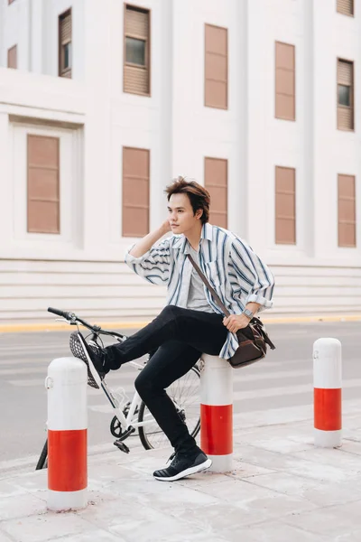 Successful handsome asia man riding bicycle