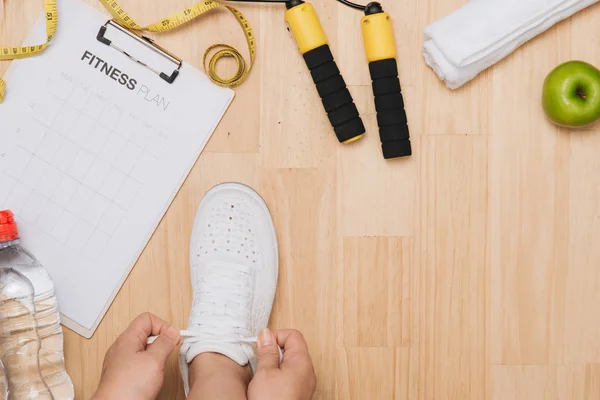 Overhead View Woman Hands Tying Shoes Sport Equipments Wood Background — Stock Photo, Image