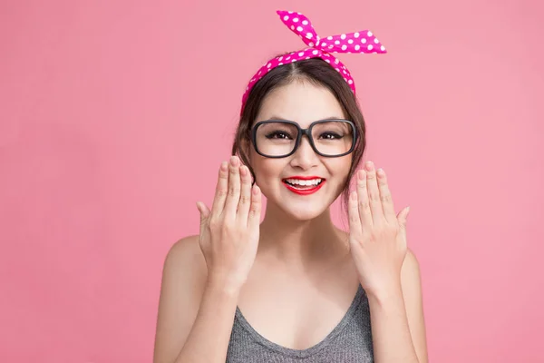 smiling asian woman wearing eyeglasses pinup style portrait on pink background. Asian woman.