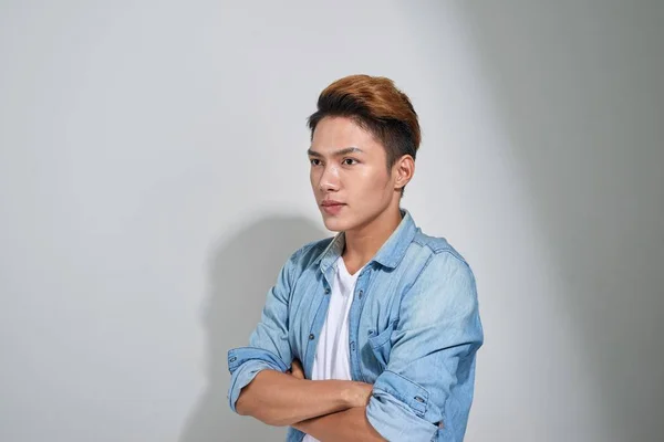 Portrait of handsome young asian guy posing in studio.