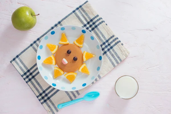 Funny pancakes with orange for kids breakfast