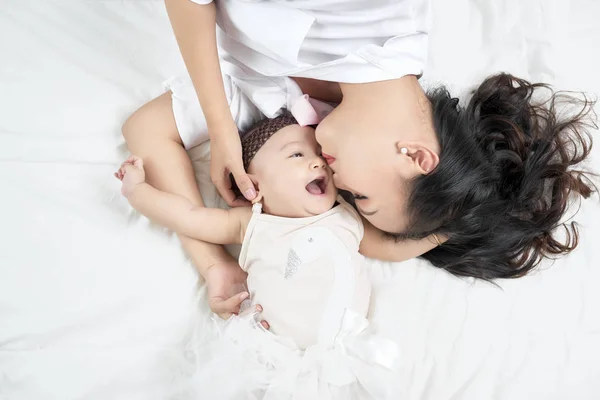 Mother Kisses Baby Lying Bed Closeup — Stock Photo, Image