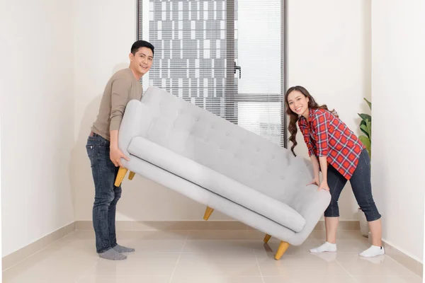 Smiling Couple Carrying Modern Chair Together Placing Furniture Moving New — Stock Photo, Image