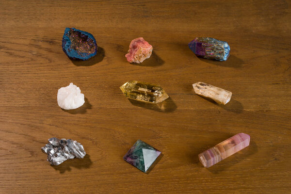 Collection of beautiful precious stones on wooden table