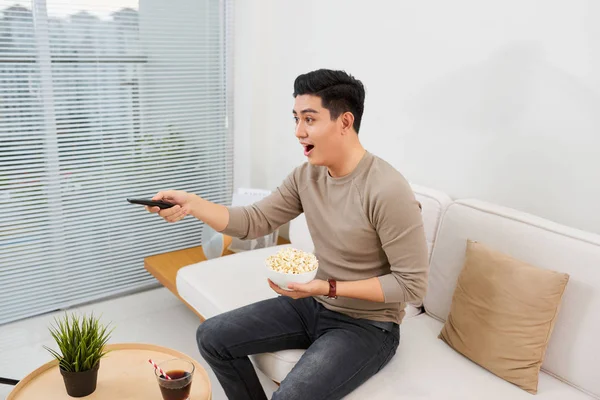 Happy Man Watching Eating Popcorn Seated Sofa Isolated White Background — Stock Photo, Image