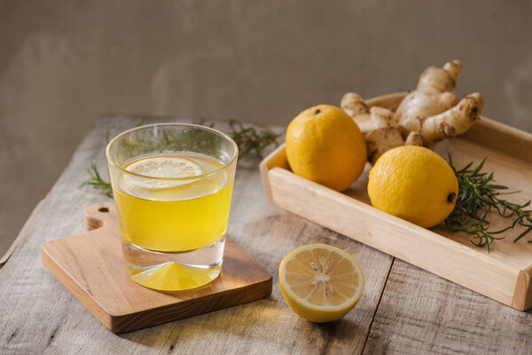 Ginger tea with lemon and rosemary on plate , Seasonal beverage concept 