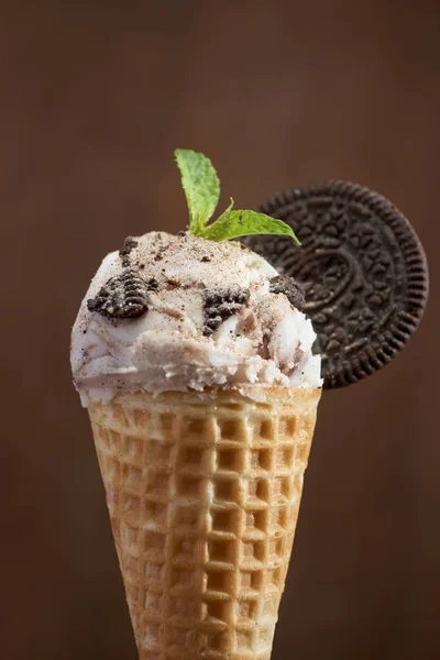 Sweet homemade ice cream with cookies in cone