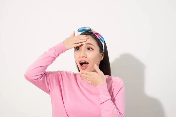 Asian woman touching face with surprise feeling on white background