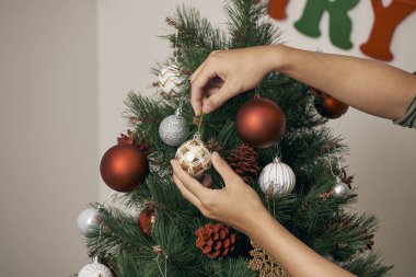 Erkek evde baubles ile dekorasyon Noel ağacı eller