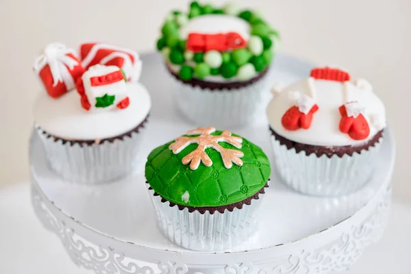 Seasonal festive christmas mini dessert cupcakes on cake stand