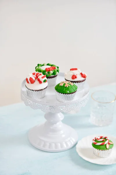 Seasonal festive christmas mini dessert cupcakes on cake stand