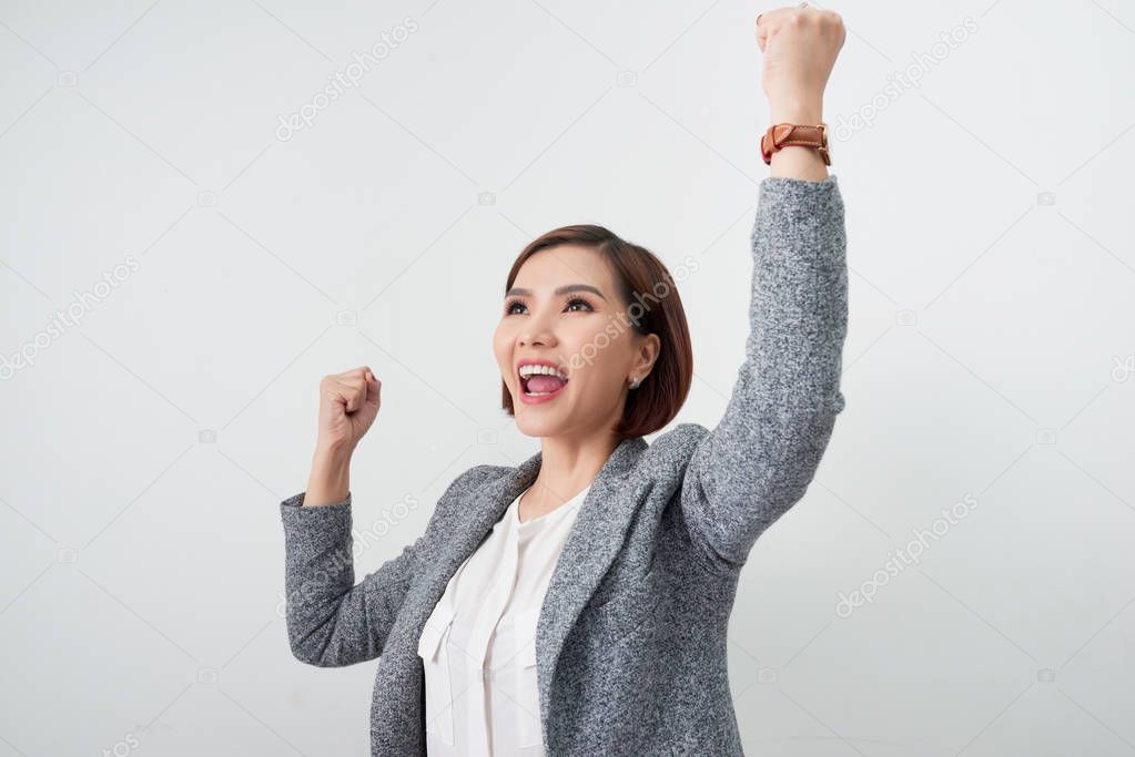 happy excited businesswoman with hands up on white background