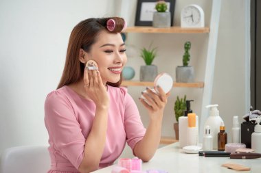 Portre sevimli oldukça sevimli yakışıklı şık trendy moda seksi uygulanan toz sabah aynaya bakmak yanaklarda sünger ile kapatmak