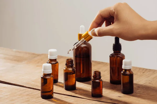 Essential Oils Bottles Wooden Desk Candlelight Spa Wellness Set — Stock Photo, Image