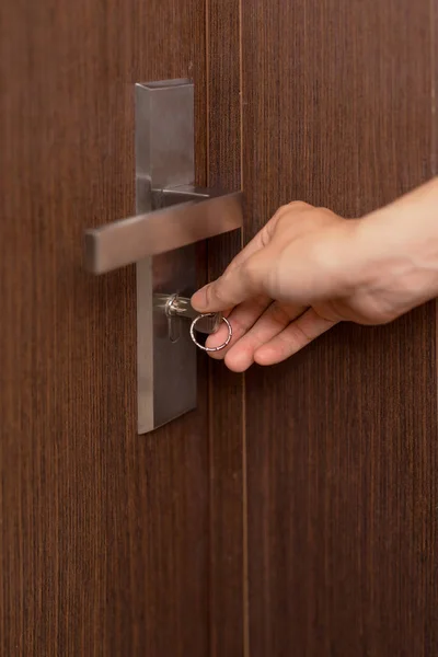 Person hand ready to open door by key. — Stock Photo, Image