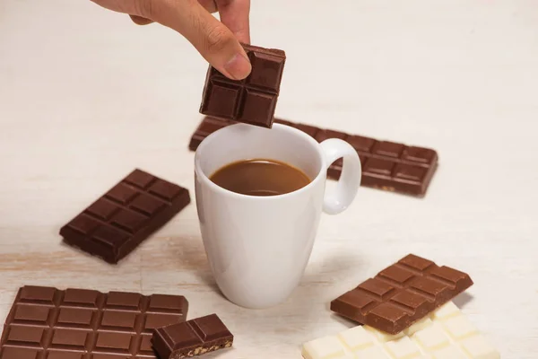 A lot of variety chocolates bar in box on white wooden backgroun