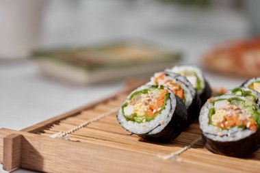 Korean roll Gimbap(kimbob) made from steamed white rice (bap) and various other ingredients clipart