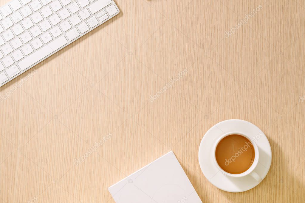 Flat lay, top view office table desk. Workspace with blank note book, keyboard, office supplies and coffee cup on wooden background.