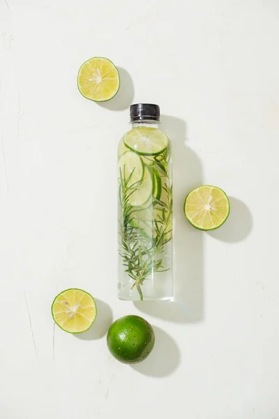 Health care, fitness, healthy nutrition diet concept. Fresh cool lemon rosemary infused water, cocktail, detox drink, lemonade in a glass jar. Light top view flat lay background
