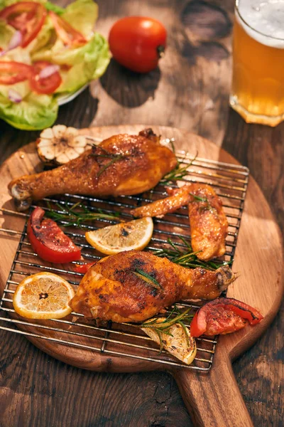 Hot and spicy chicken drumstick and wings closeup with beer