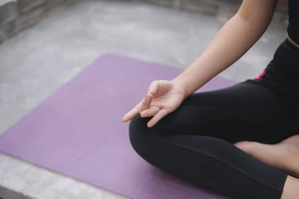 Asian woman relax in the holiday. Play if yoga. On the balcony